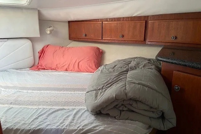 Slide: The Image of Cozy cabin interior of 2000 Carver 406 Aft Cabin Motor Yacht with bed and wooden cabinets. - 28