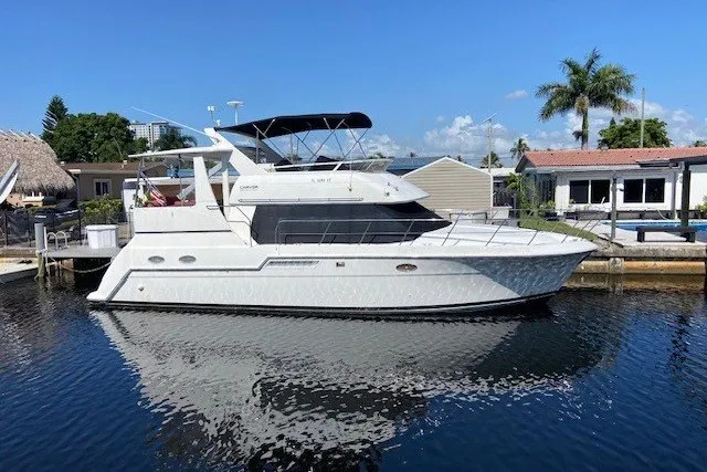 The Image of 2000 Carver 406 Aft Cabin Motor Yacht docked in sunny marina setting. - 0