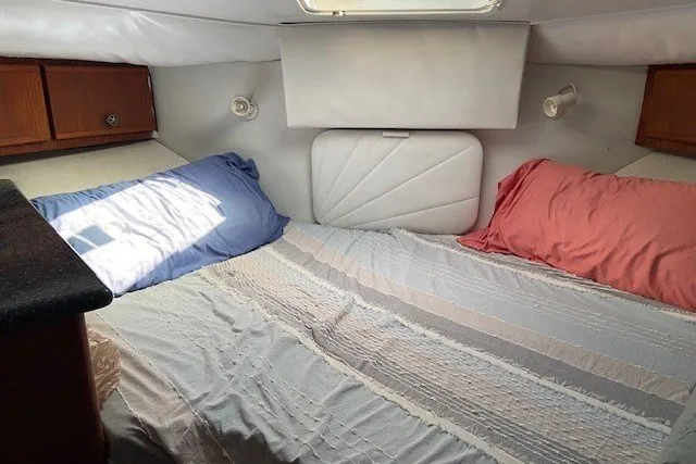 Slide: The Image of Cozy cabin interior of 2000 Carver 406 Aft Cabin Motor Yacht with bed and pillows. - 27
