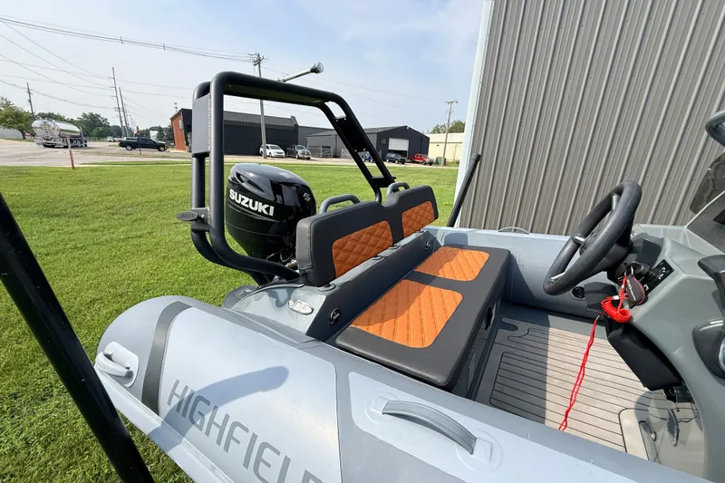 Slide: The Image of 2023 Highfield Sport 420 boat with Suzuki engine, featuring orange seats and sleek design. - 6