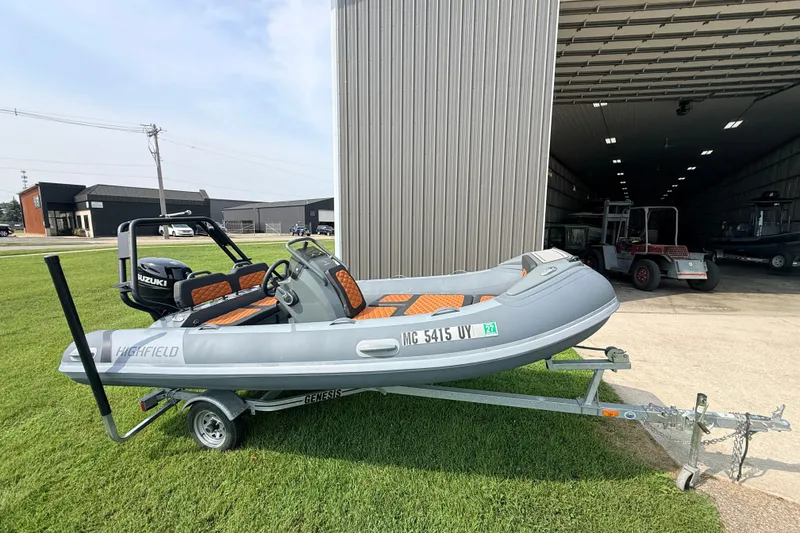 The Image of 2023 Highfield Sport 420 boat on trailer, parked outside a large garage. - 4
