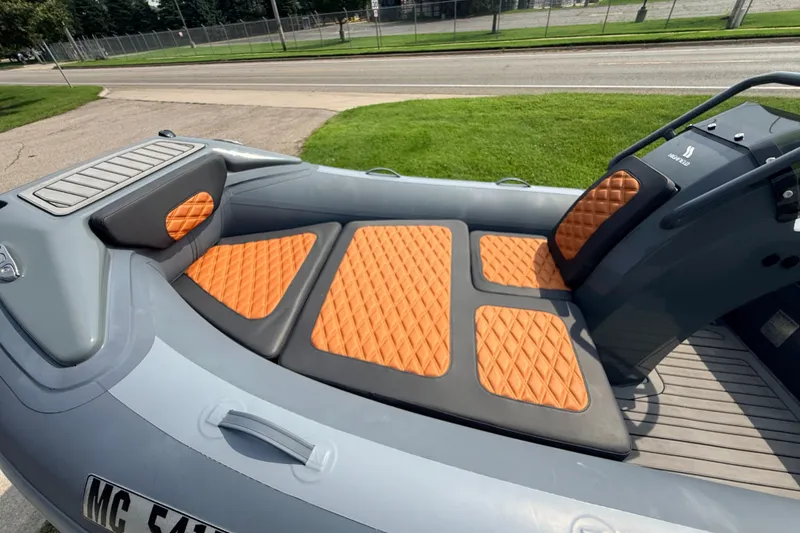 Slide: The Image of 2023 Highfield Sport 420 boat with orange diamond-patterned seating and sleek design. - 8