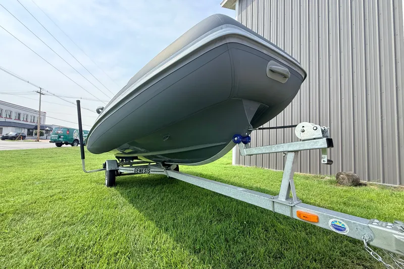 Slide: The Image of 2023 Highfield Sport 420 boat on trailer, parked on grass beside a building. - 15