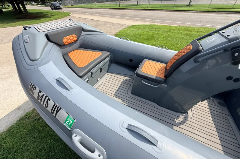 Slide: The Image of 2023 Highfield Sport 420 boat with orange seats and sleek gray design. - 7