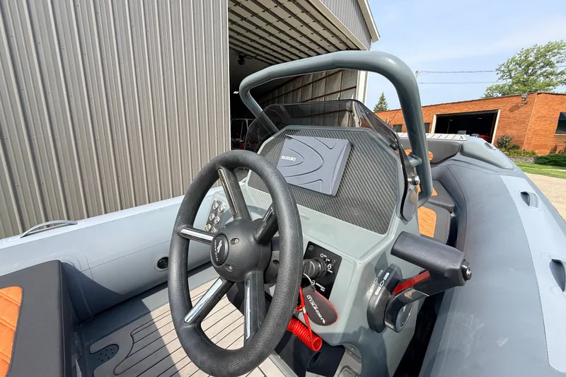 Slide: The Image of 2023 Highfield Sport 420 boat interior with steering wheel and control panel. - 17