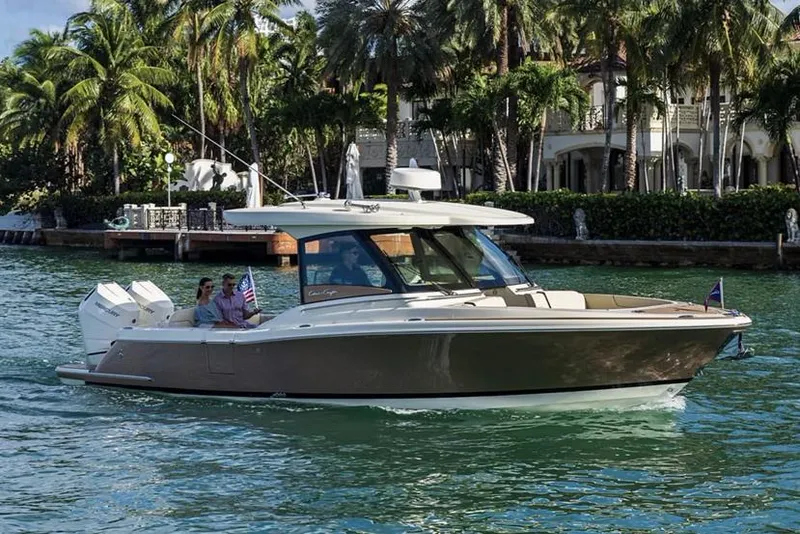 The Image of Manufacturer Provided Image: 2025 Chris-Craft Calypso 32 cruising on tropical waters with palm trees in the background. - 0
