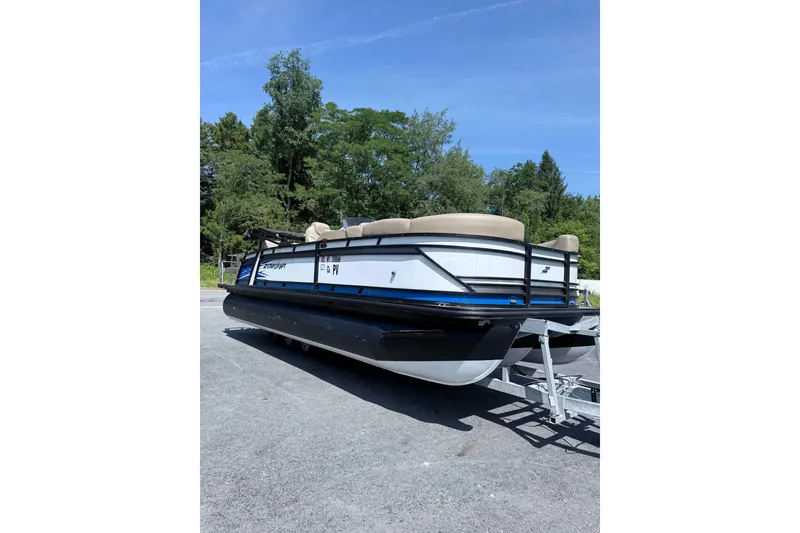 The Image of 2021 Starcraft CX 23 RL pontoon boat on trailer, parked outdoors. - 0