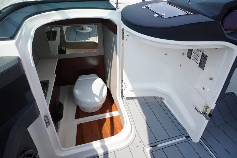 Slide: The Image of Interior view of 2027 Chaparral 270 OSX boat bathroom with toilet and mirror. - 22