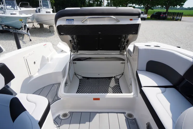 Slide: The Image of 2027 Chaparral 270 OSX boat interior with open storage compartment and seating area. - 55
