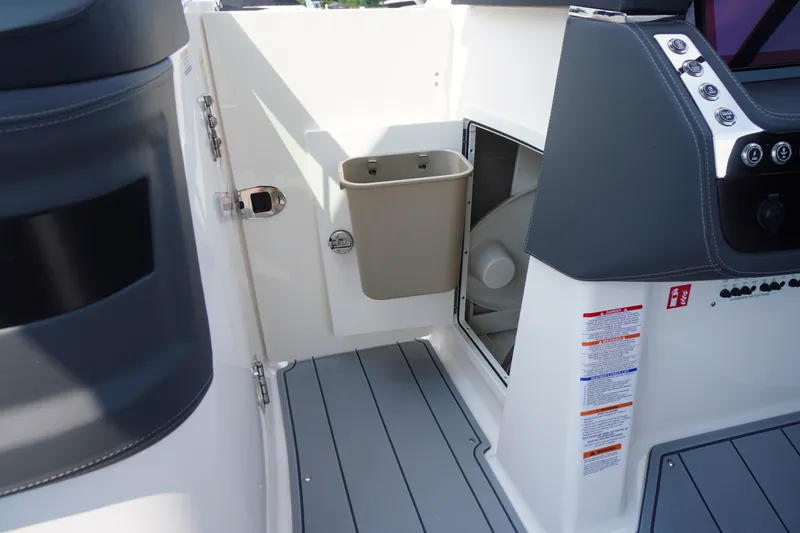 Slide: The Image of Interior view of 2027 Chaparral 270 OSX boat, featuring sleek design and storage compartment. - 16