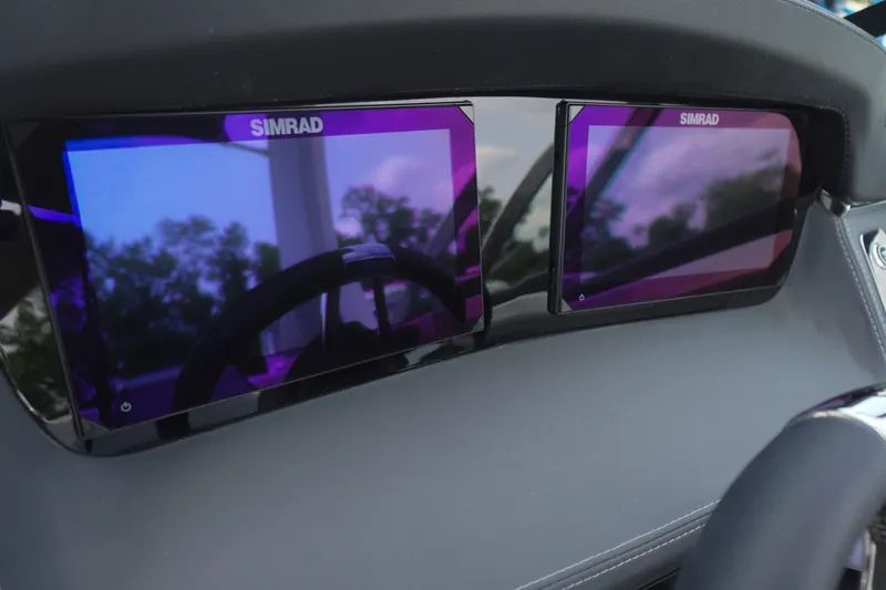 Slide: The Image of Simrad displays on the dashboard of a 2027 Chaparral 270 OSX boat. - 29