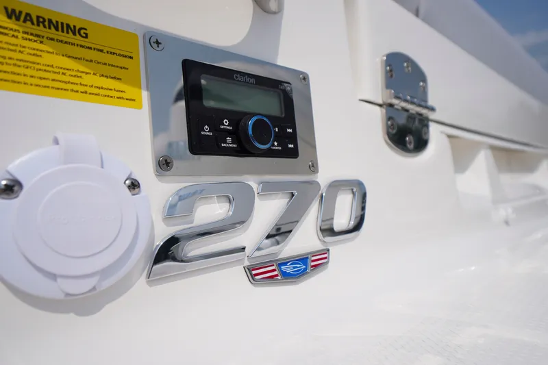 Slide: The Image of Close-up of 2027 Chaparral 270 OSX boat dashboard with control panel and logo. - 61