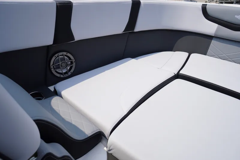 Slide: The Image of 2027 Chaparral 270 OSX boat interior with cushioned seating and built-in speaker. - 6