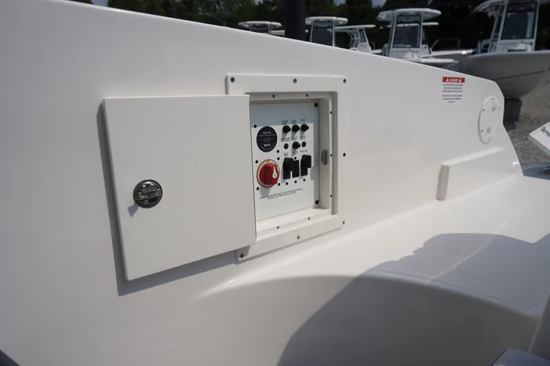 Slide: The Image of Control panel on a 2027 Chaparral 270 OSX boat, featuring switches and a red knob. - 58