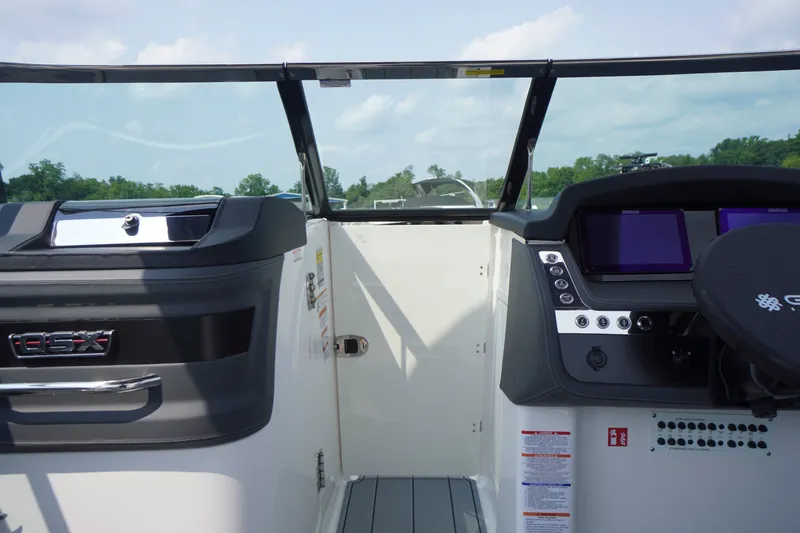 Slide: The Image of 2027 Chaparral 270 OSX boat dashboard with modern controls and dual screens. - 15