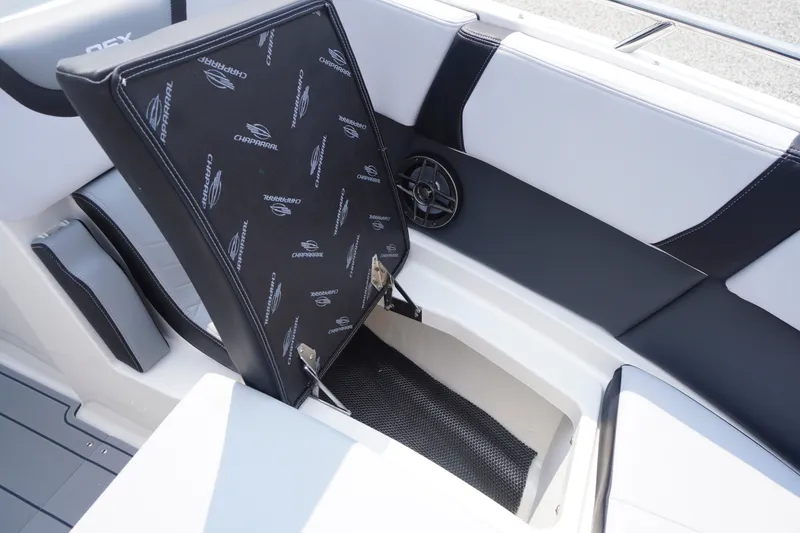 Slide: The Image of 2027 Chaparral 270 OSX boat seat storage compartment, featuring sleek black and white design. - 12