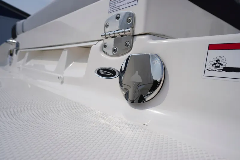 Slide: The Image of Close-up of 2027 Chaparral 270 OSX boat detail, featuring chrome hardware and textured surface. - 62