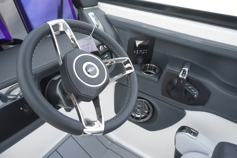 Slide: The Image of Steering wheel and controls of 2027 Chaparral 270 OSX boat cockpit. - 27