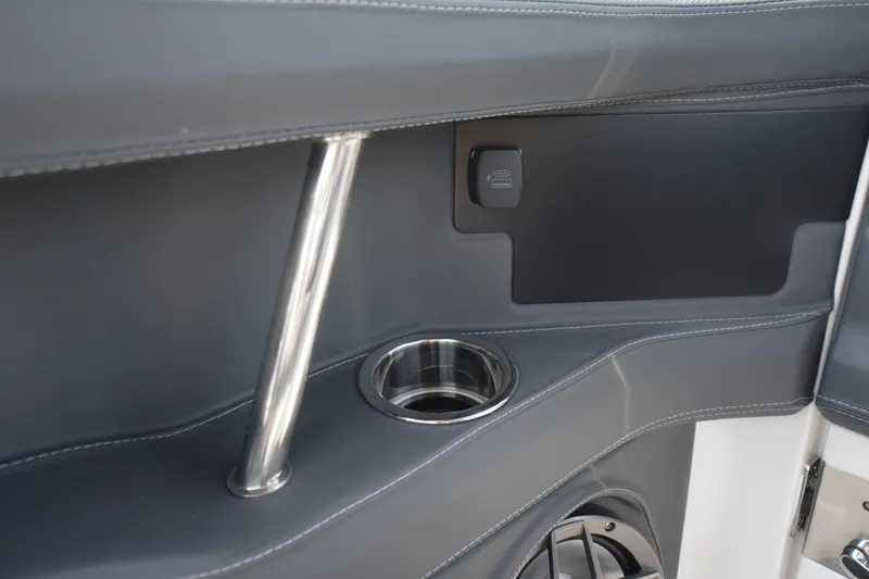 Slide: The Image of Interior detail of 2027 Chaparral 270 OSX boat, featuring cup holder and sleek design. - 52