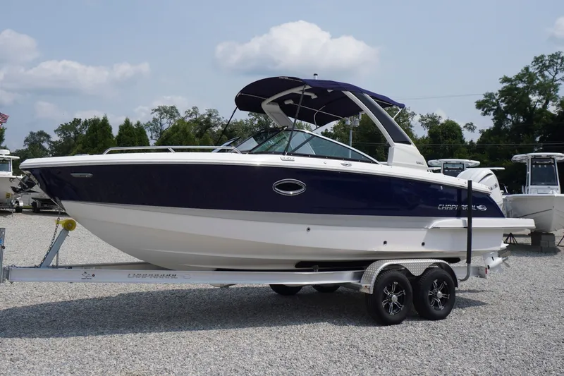 The Image of 2027 Chaparral 270 OSX boat on trailer, displayed outdoors under a clear sky. - 0