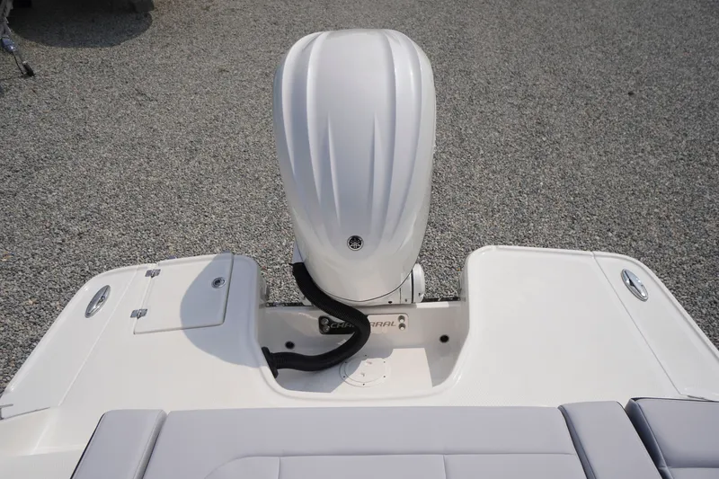 Slide: The Image of 2027 Chaparral 270 OSX boat engine and deck view on gravel surface. - 64
