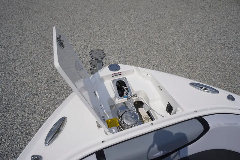 Slide: The Image of Open anchor compartment on 2027 Chaparral 270 OSX boat, showcasing storage and equipment. - 3