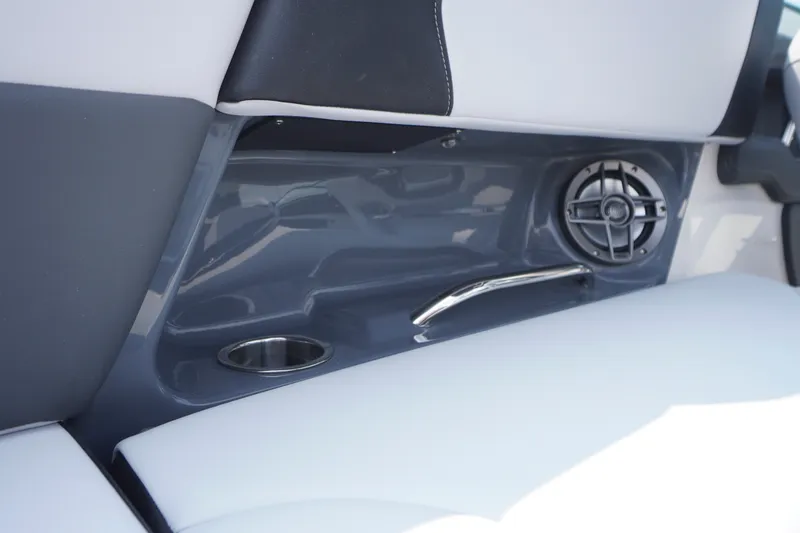 Slide: The Image of Interior detail of 2027 Chaparral 270 OSX boat, featuring speaker and cup holder. - 50