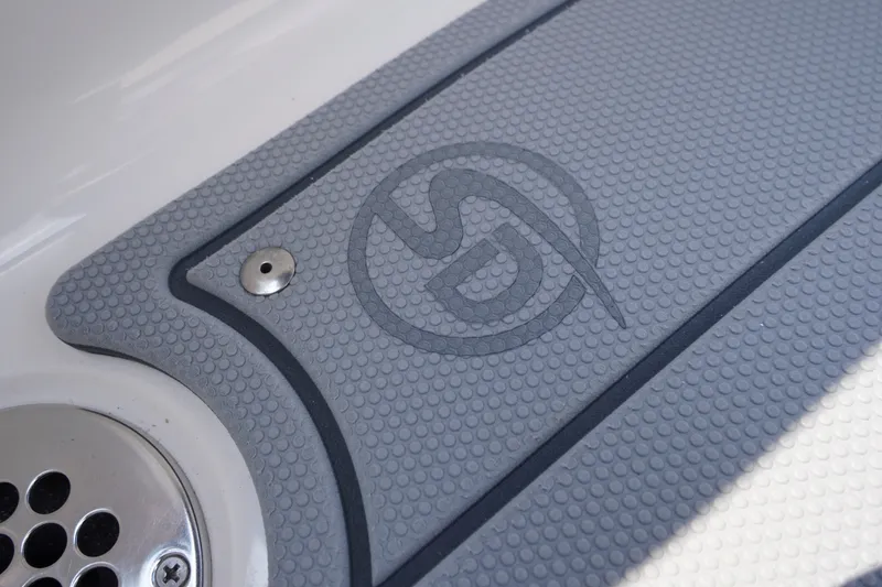 Slide: The Image of Close-up of 2027 Chaparral 270 OSX boat deck with logo and textured surface. - 46