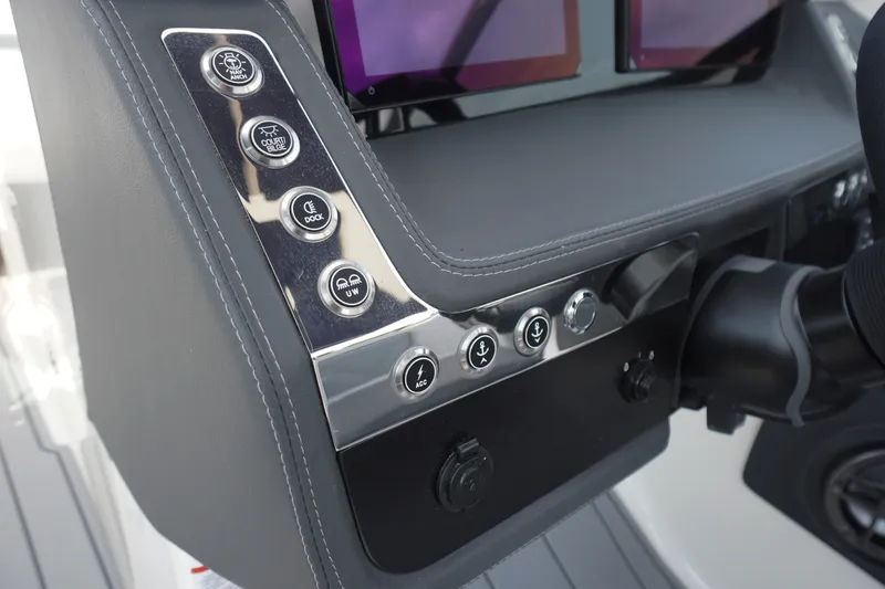 Slide: The Image of Dashboard controls of 2027 Chaparral 270 OSX boat with modern buttons and displays. - 28