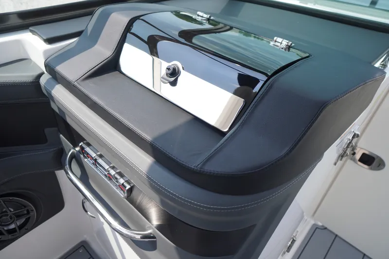 Slide: The Image of 2027 Chaparral 270 OSX boat dashboard with sleek black and chrome design. - 18