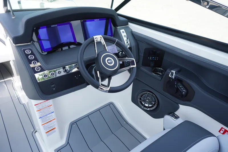 Slide: The Image of 2027 Chaparral 270 OSX boat cockpit with modern steering and dual displays. - 26