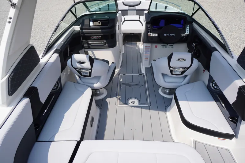 Slide: The Image of Interior view of 2027 Chaparral 270 OSX boat, featuring modern seating and dashboard. - 13