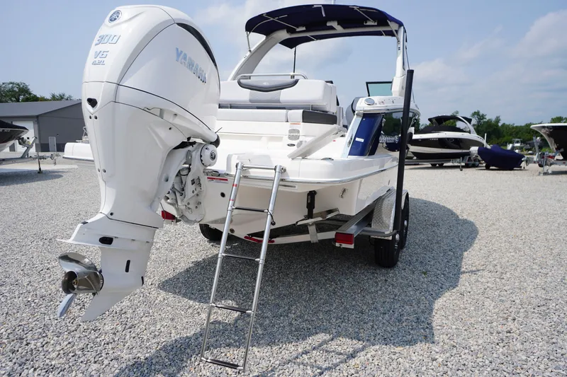 Slide: The Image of 2027 Chaparral 270 OSX boat with Yamaha 300 V6 engine, displayed on gravel lot. - 65