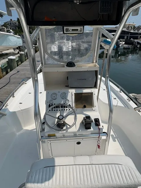 Slide: The Image of The image shows the cockpit of a 2004 Sea Pro SV2100CC Bay Boat with a steering console. - 2