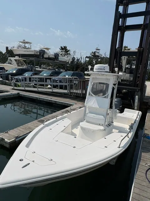 Slide: The Image of A white 2004 Sea Pro SV2100CC Bay Boat is docked. It features a Garmin navigation system. - 3