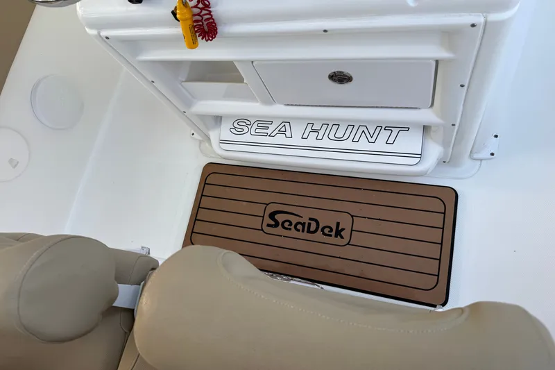 Slide: The Image of 2018 Sea Hunt Gamefish 27 interior with SeaDek flooring and storage compartment. - 25