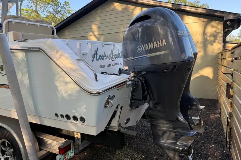 Slide: The Image of 2018 Sea Hunt Gamefish 27 boat with Yamaha 200 outboard motor, parked outdoors. - 13