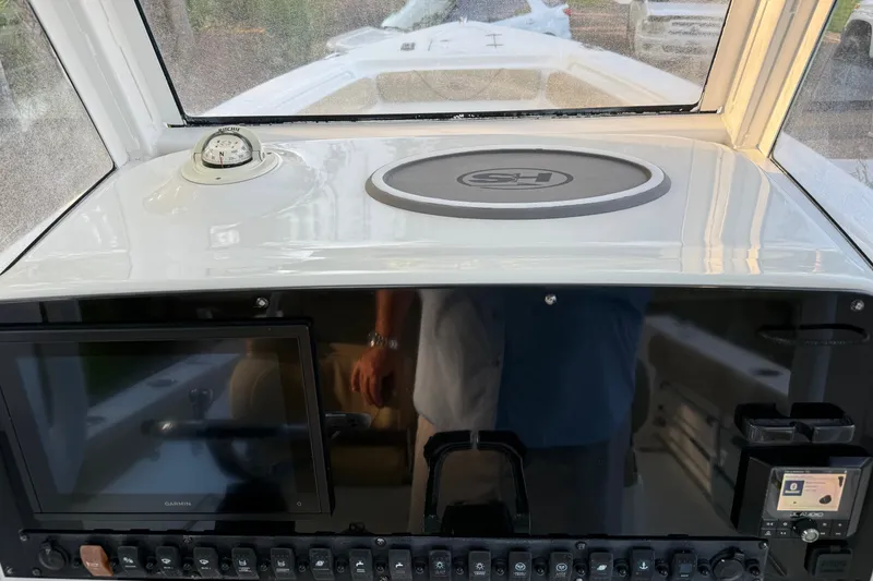 Slide: The Image of 2018 Sea Hunt Gamefish 27 dashboard with compass, touchscreen, and control panel. - 48