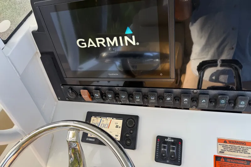 Slide: The Image of Garmin display and controls on 2018 Sea Hunt Gamefish 27 boat dashboard. - 44