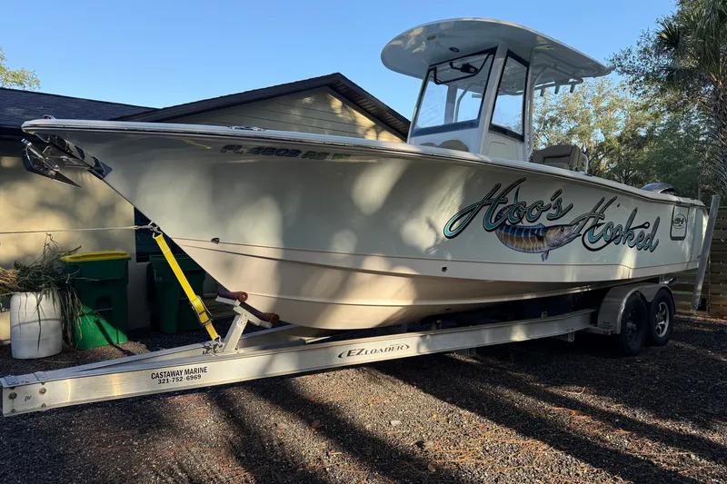Slide: The Image of 2018 Sea Hunt Gamefish 27 boat on trailer, parked outdoors. - 11