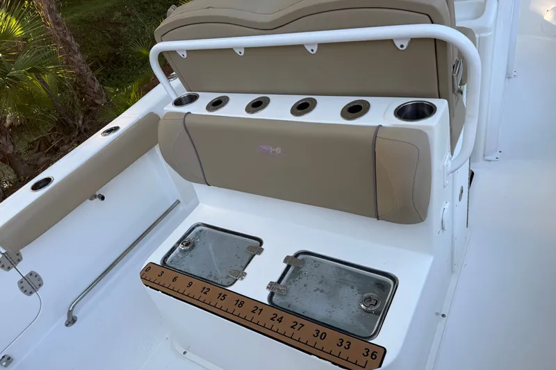 Slide: The Image of 2018 Sea Hunt Gamefish 27 boat interior with tan seating and fishing rod holders. - 20