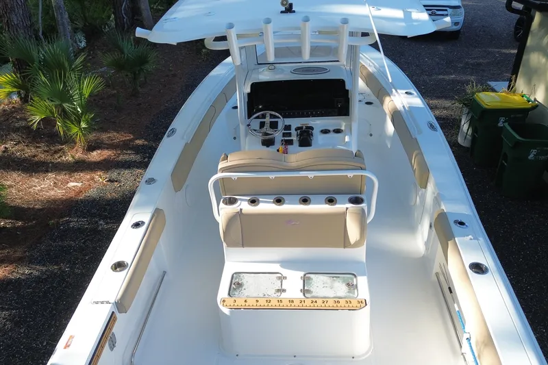 Slide: The Image of 2018 Sea Hunt Gamefish 27 boat interior with helm, seating, and fishing rod holders. - 4