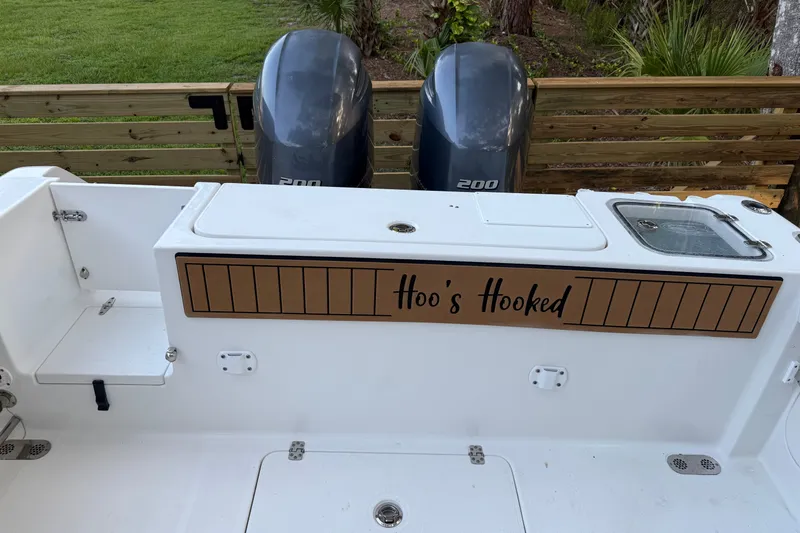 Slide: The Image of 2018 Sea Hunt Gamefish 27 boat with twin 200 engines, "Hoo's Hooked" decal. - 18