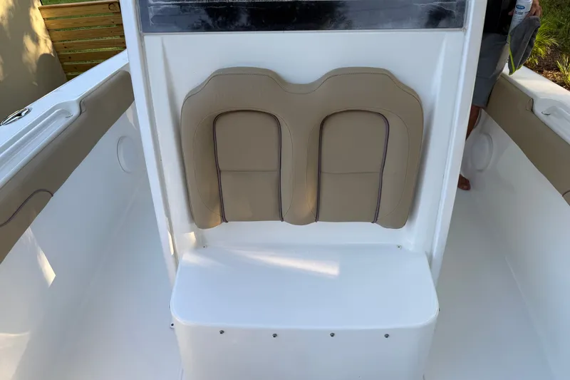 Slide: The Image of 2018 Sea Hunt Gamefish 27 boat seating area with beige cushions. - 32