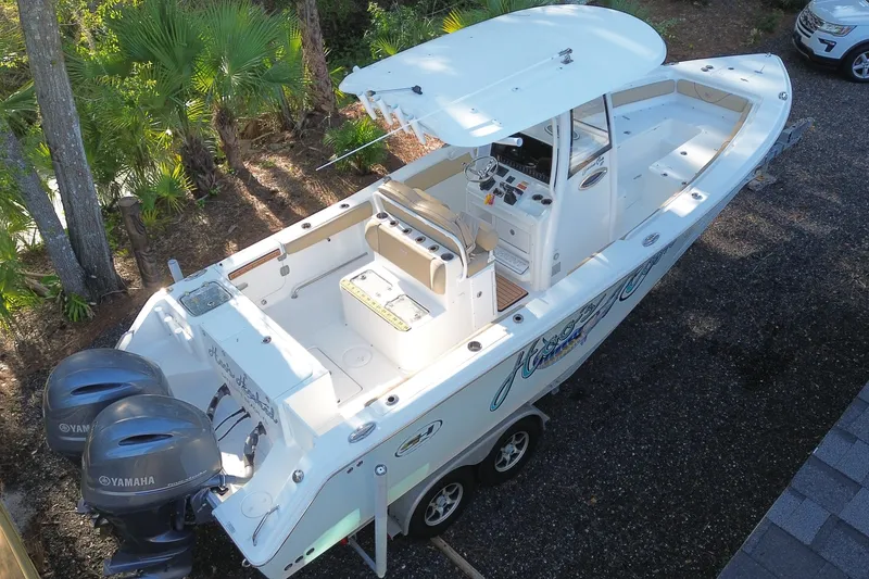 Slide: The Image of 2018 Sea Hunt Gamefish 27 boat with dual Yamaha engines, parked on a trailer. - 5