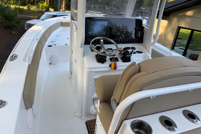 Slide: The Image of 2018 Sea Hunt Gamefish 27 boat interior with steering console and seating. - 22