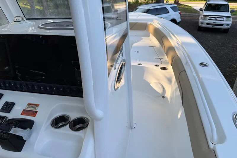 Slide: The Image of 2018 Sea Hunt Gamefish 27 boat interior with control panel and seating area. - 31