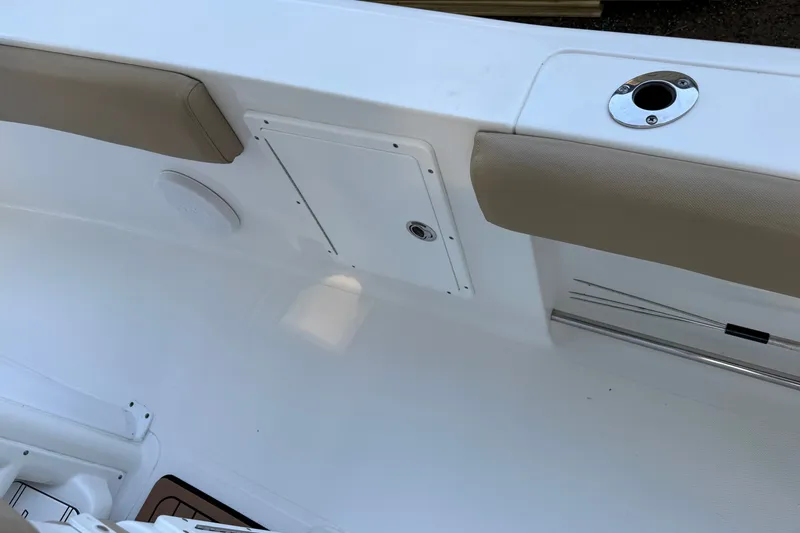 Slide: The Image of 2018 Sea Hunt Gamefish 27 boat interior with cushioned seating and storage compartment. - 26