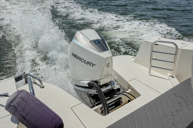 Slide: The Image of 2024 Nimbus Commuter 9 with Mercury Verado engine cruising on water. - 9