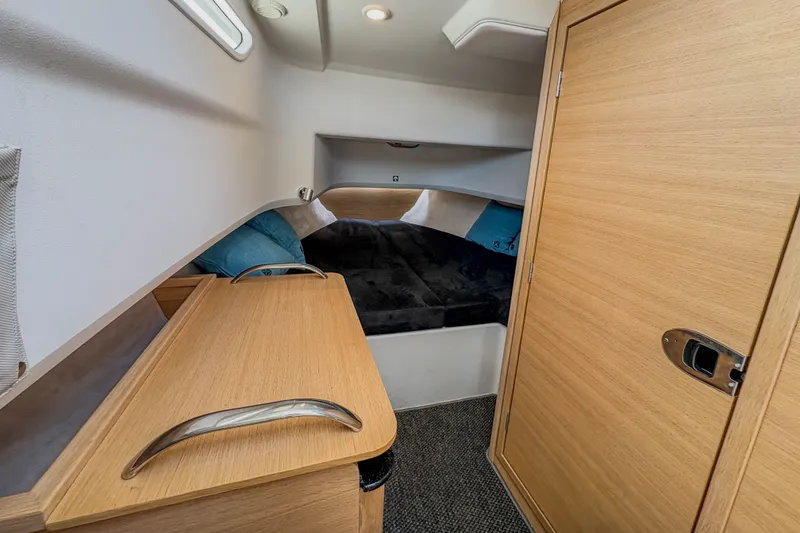 Slide: The Image of 2024 Nimbus Commuter 9 cabin interior with wooden finishes and cozy sleeping area. - 18